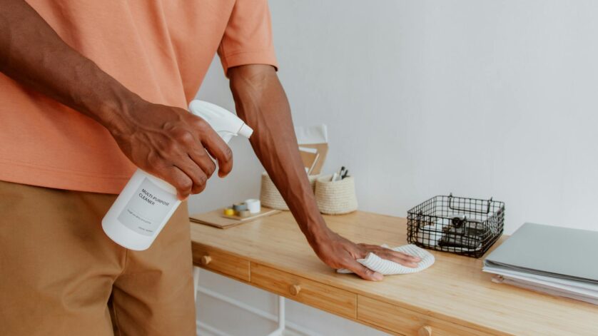 man cleaning desk