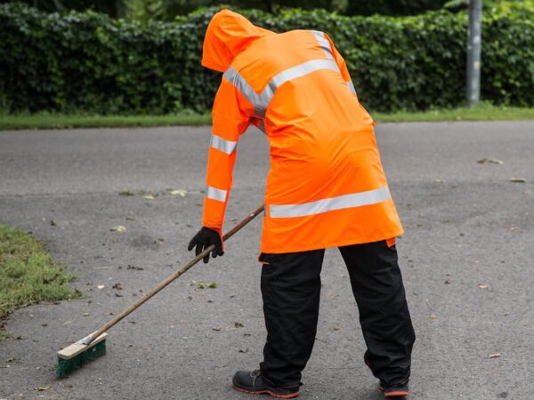 street sweeper wearing reflective clothing