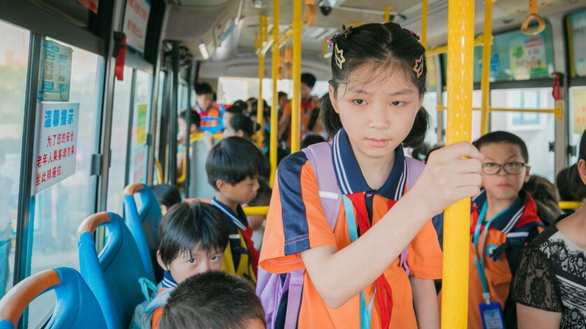 teenager schoolgirl riding on a bus with her class