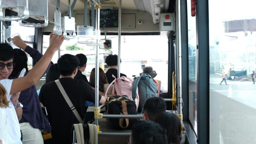 commuters inside a busy city bus interior view