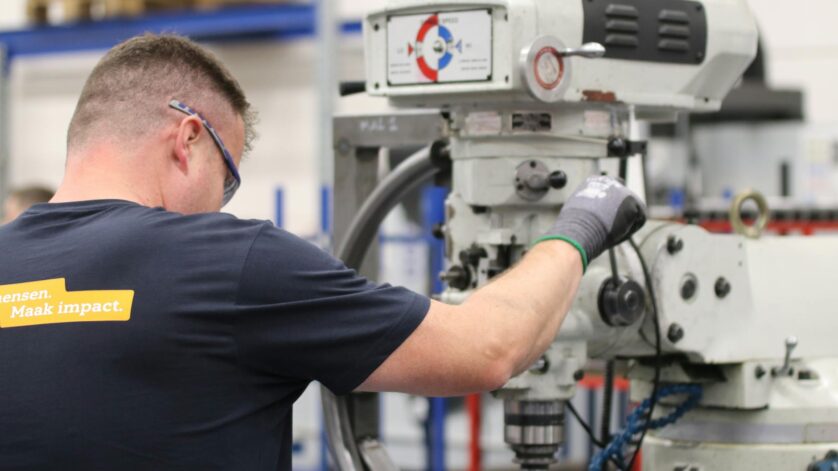 industrial worker operating milling machine