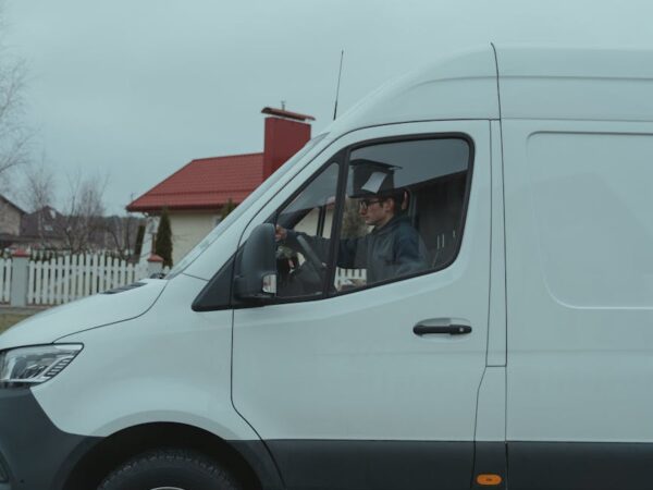 man driving a white van